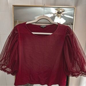 Honey Pot burgundy blouse features dramatic sheer puff sleeves.